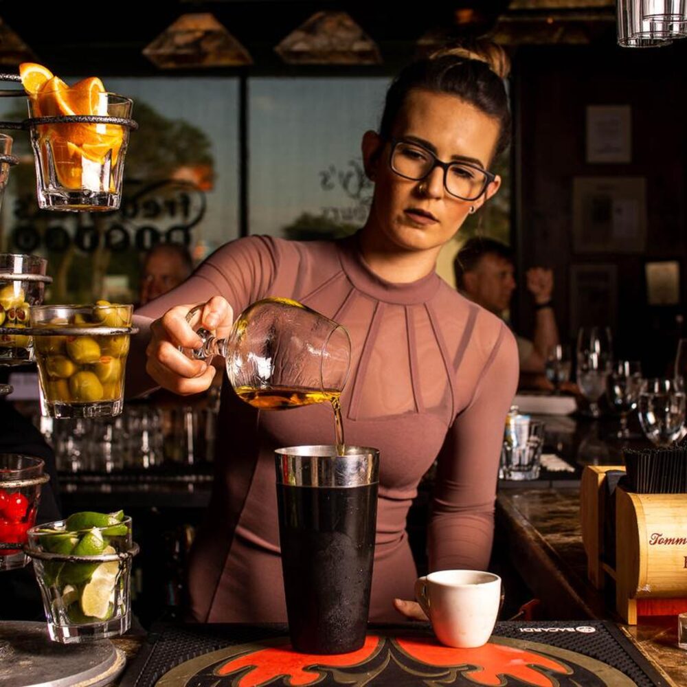 A bartender mixing a cocktail at Frederick's Bistro